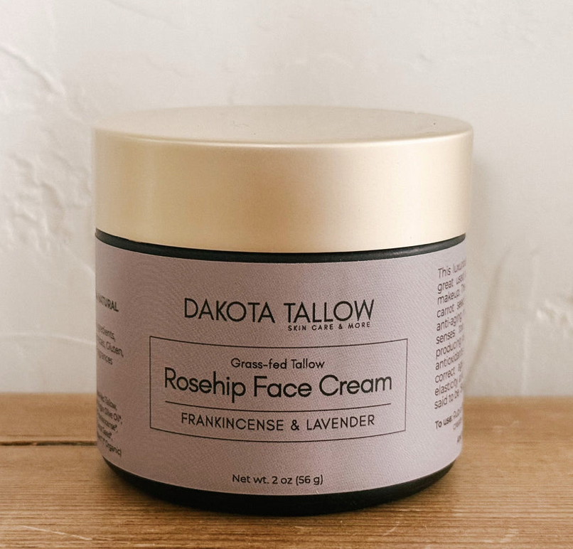 Dakota Tallow Rosehip Face Cream jar on a wooden surface with a white background
