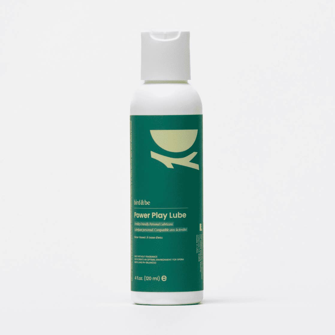 Green and white bottle of Power Play Lube on a white background