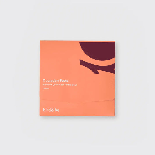 Orange packaging of ovulation tests with 'bird & be' branding on a light gray background